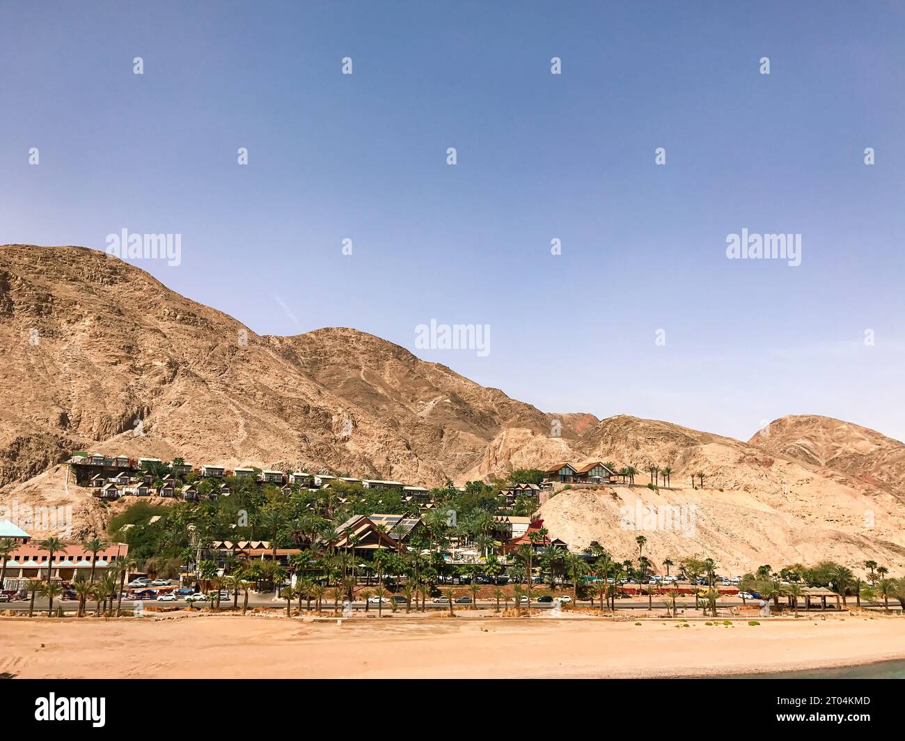 Orchid Eilat beachfront hotel located mountainside overlooking the Red Sea Bay and the Red Mountains Stock Photo