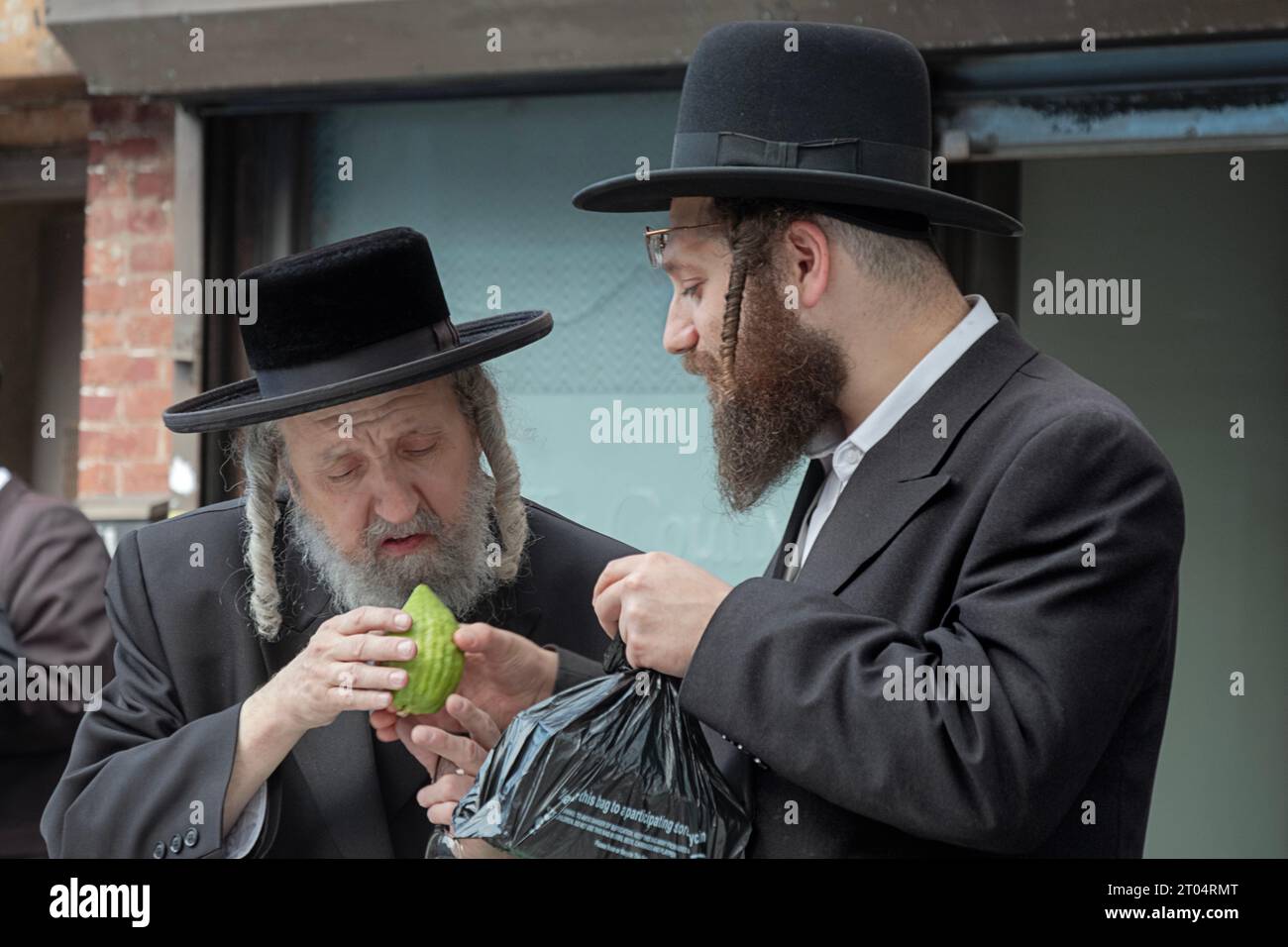 Two orthodox Jewish men shop for an esrog while preparing for the Sukkos holiday. On Lee Avnue in Willliamsburg. Stock Photo