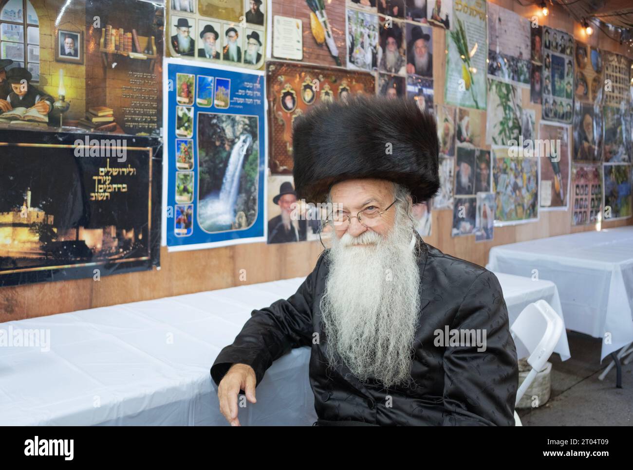 A Jewish man wearing a shtreimel fur hat poses for a photo in a Sukkah on Sukkot. In Monsey, Rockland County, New York. Stock Photo