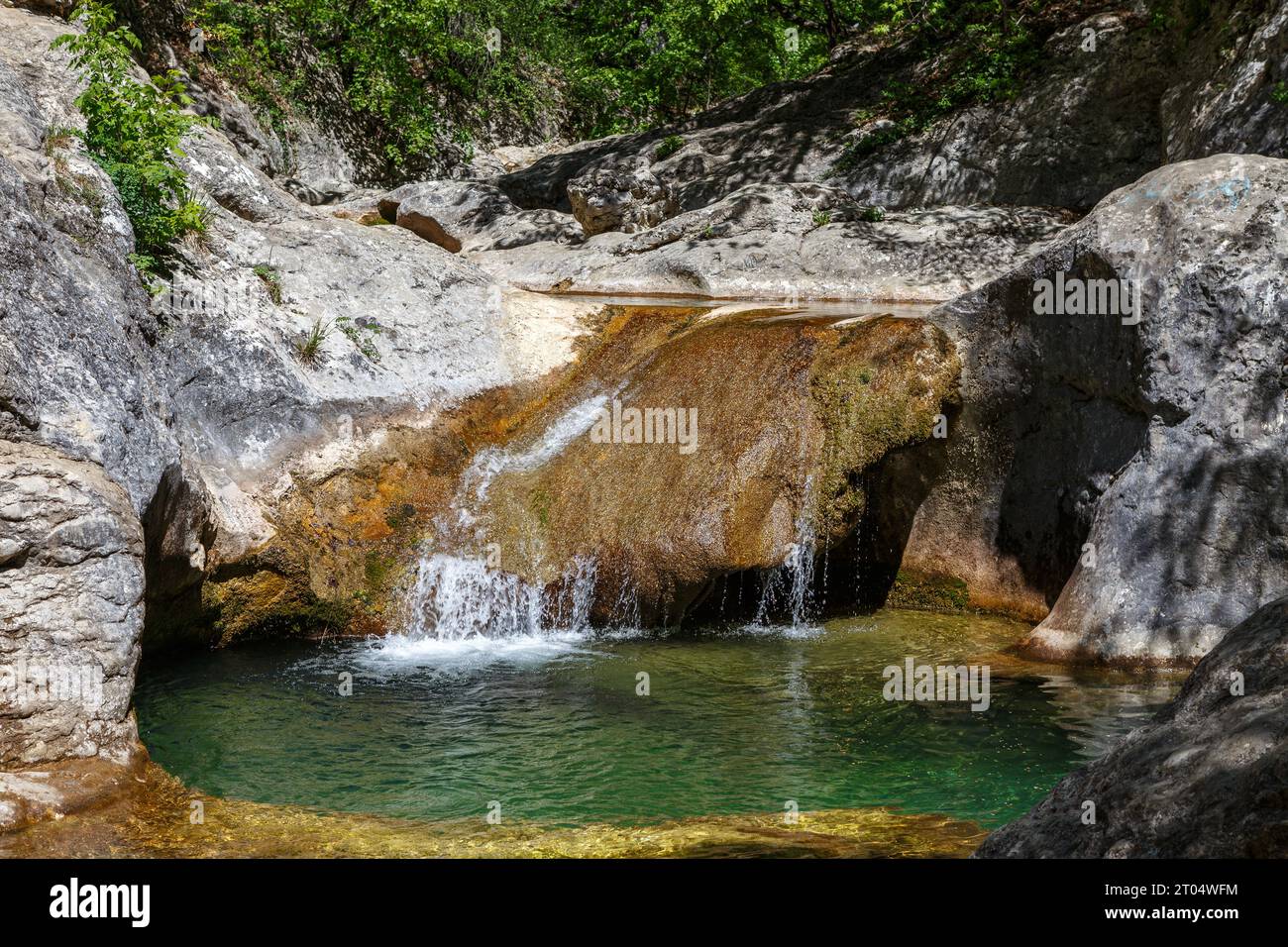 It is a small lake: about 5 m across and 5 m deep. The Bath of Youth is filled with clear cold water from a mountain spring. The water temperature nev Stock Photo