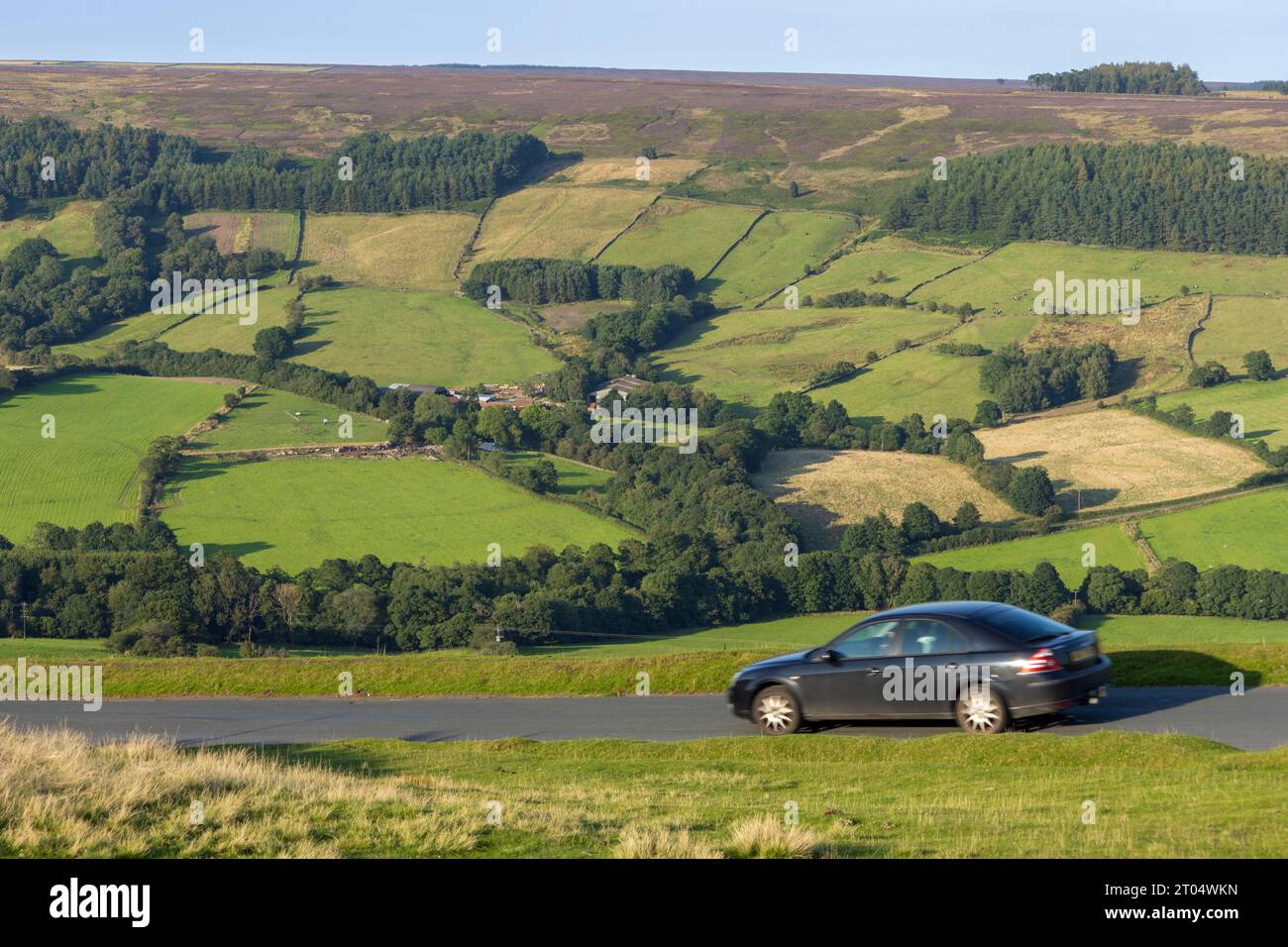 Car driving through Bank Top with Rosedale Abbey in the background, North Yorkshire Moors National Park, England, UK. Stock Photo