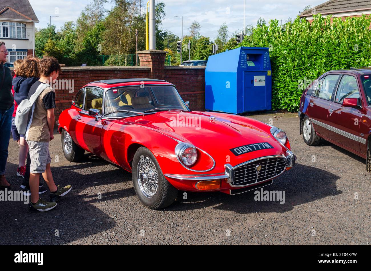 Carryduff, County Down, Northern Ireland September 23 2023 - Red E-Type being admired by people at car show Stock Photo