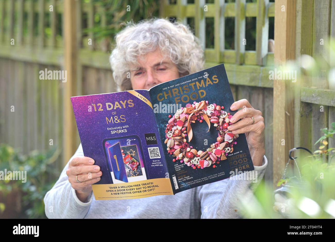 Woman reading the Marks & Spencer ( M&S) Christmas food ordering