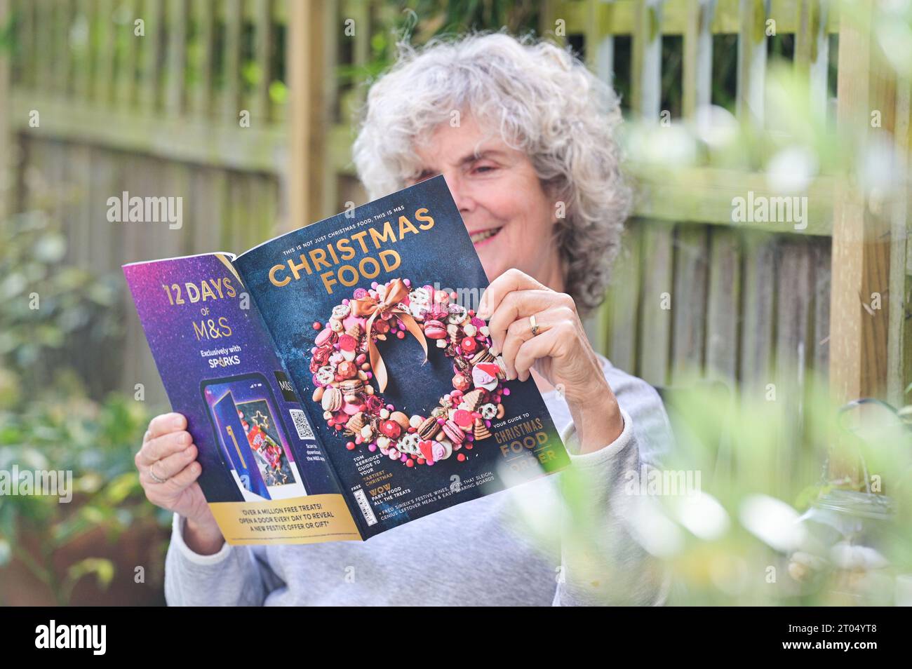 Woman reading the Marks & Spencer ( M&S) Christmas food ordering