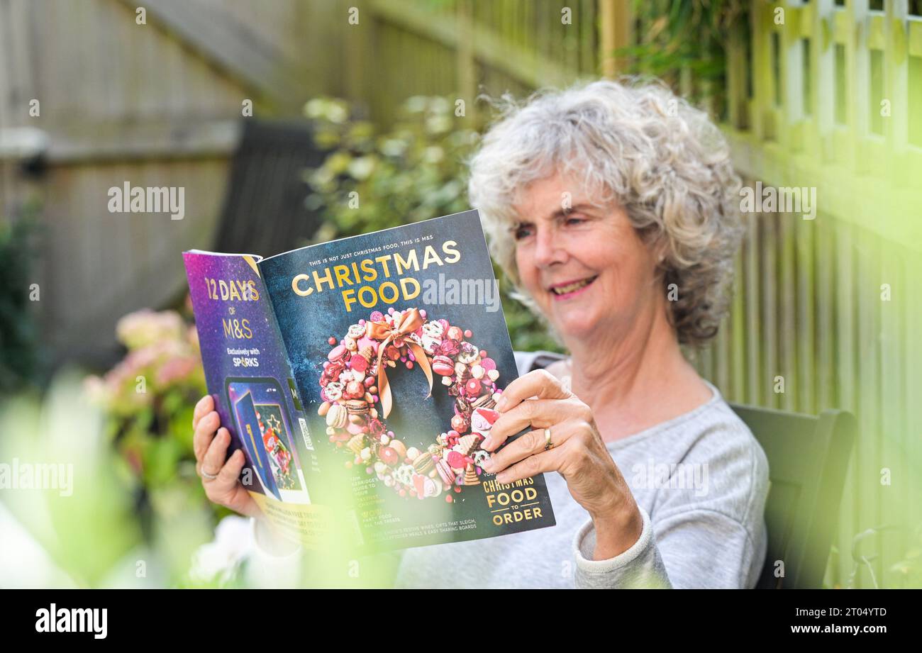 Woman reading the Marks & Spencer ( M&S) Christmas food ordering