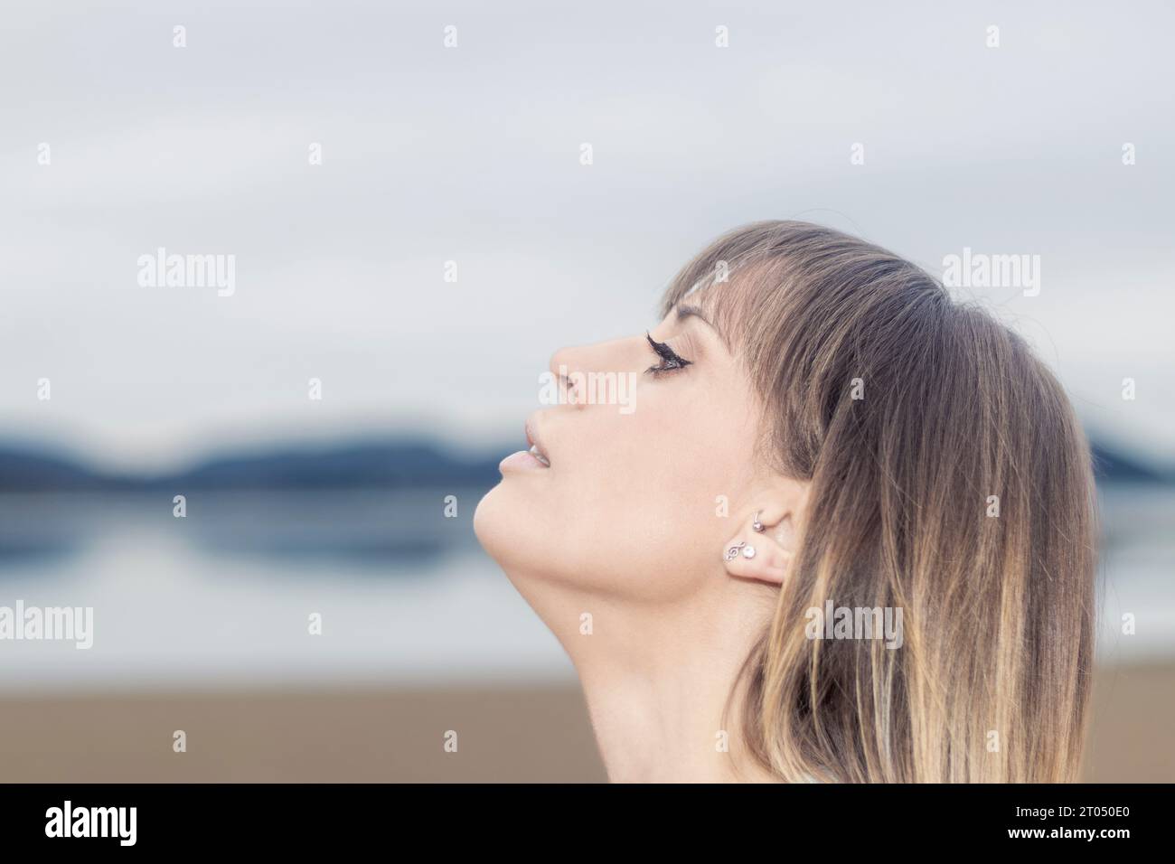Ethereal Beauty: Graceful Woman's Dreamy Gaze into the Infinite Horizon Captures the Essence of Hope Stock Photo
