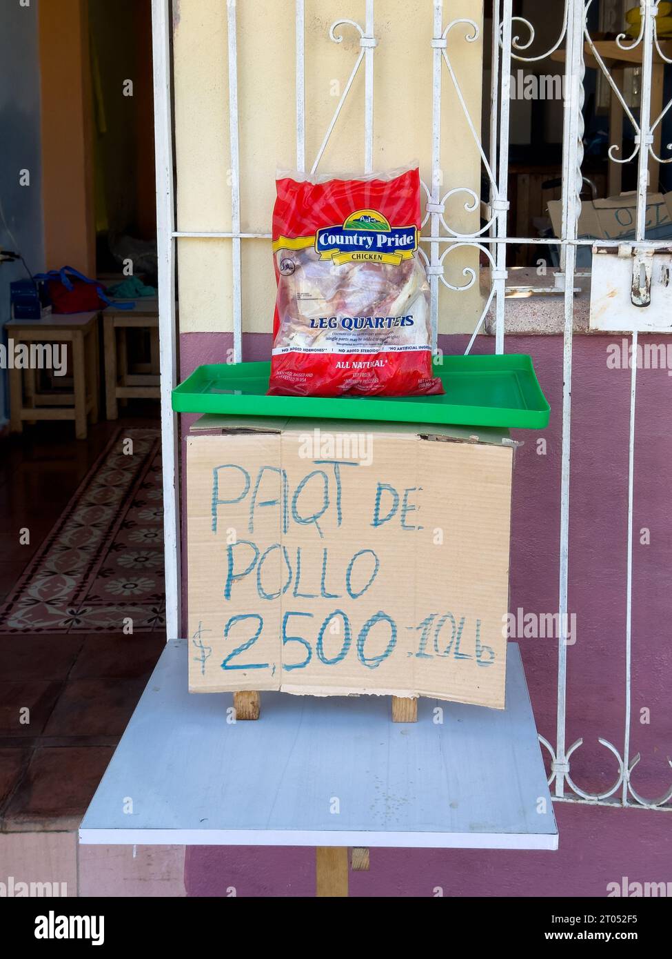 A private small business set on a house exterior sells a 10 pound chicken package for 2500 Cuban pesos.Santa Clara, Cuba, 2023 Stock Photo