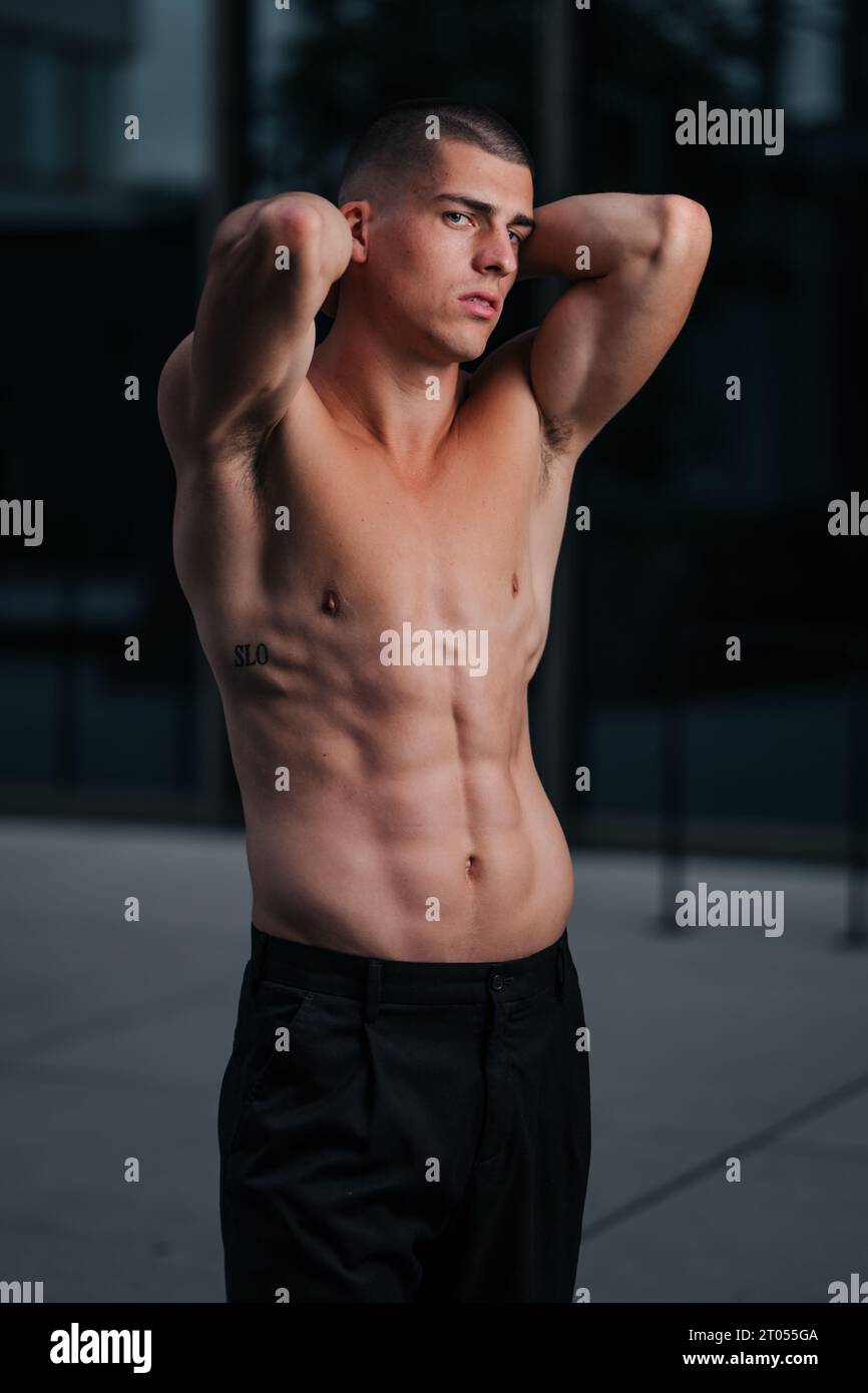 a-caucasian-muscular-shirtless-man-wearing-all-black-pants-and-posing