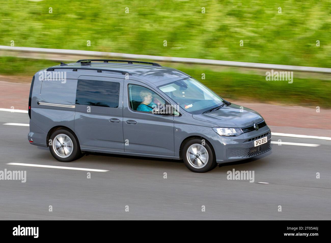 2021 Grey VW Volkswagen Caddy Maxi C20 Comm Pro TDi SA 1968cc 7 speed semi-automatic; travelling at speed on the M6 motorway in Greater Manchester, UK Stock Photo