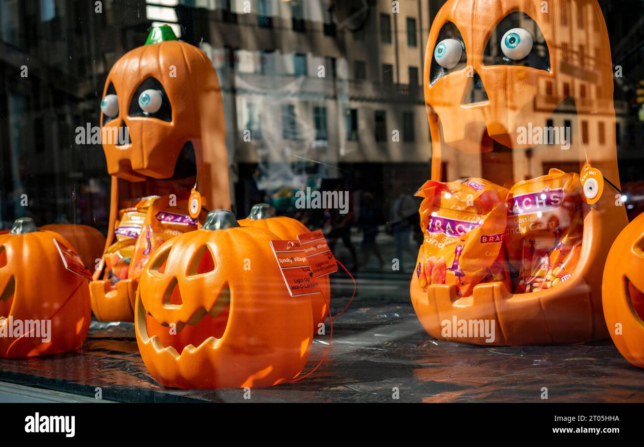 A display of Halloween pumpkins in the window of a CVS Health drugstore