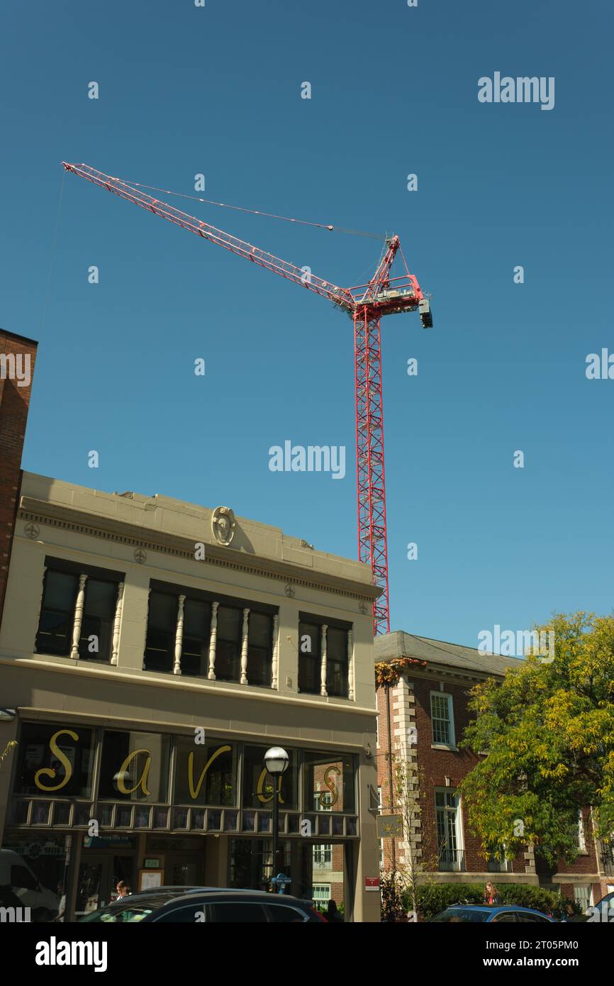 Construction crane high above buildings in Ann Arbor Michigan Stock Photo