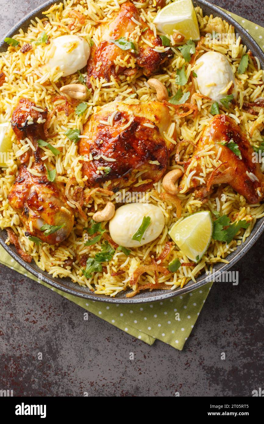 Morog Polao tender chicken cooked in ghee and flavored with a variety of spices, layered with aromatic Basmati rice closeup on the plate on the table. Stock Photo