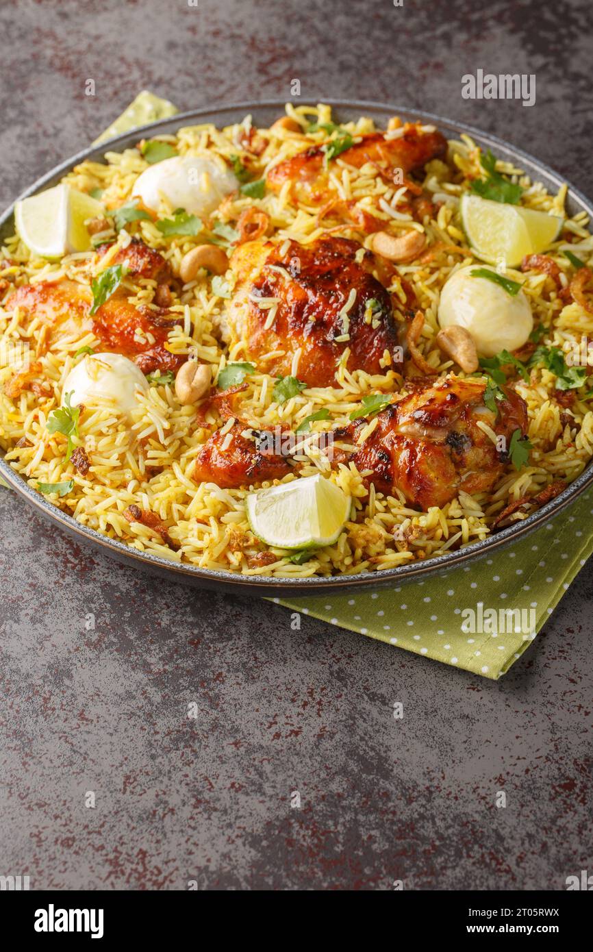 Spicy chicken biriyani rice with sliced eggs closeup on the plate on the table. Vertical Stock Photo
