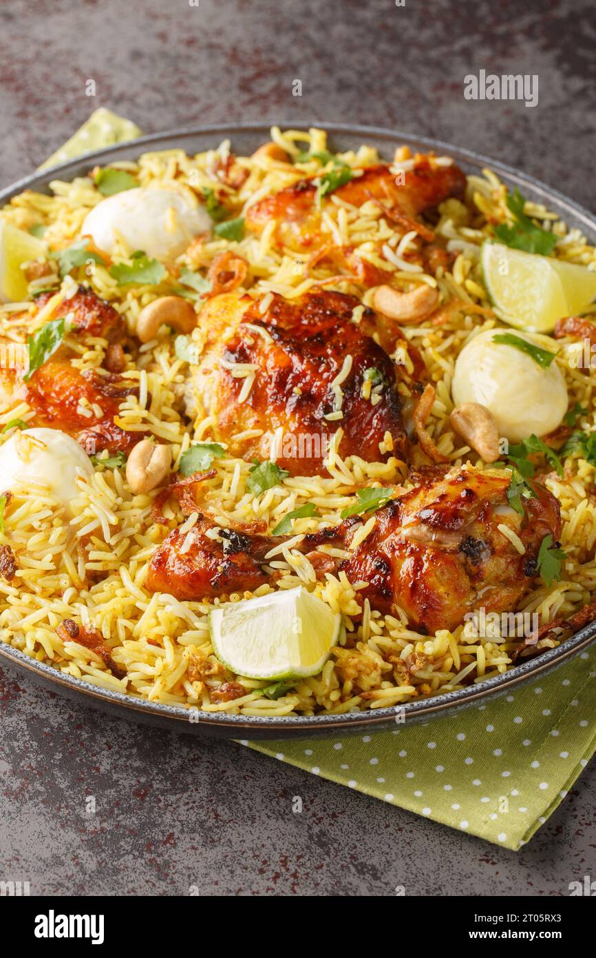 Morog Polao tender chicken cooked in ghee and flavored with a variety of spices, layered with aromatic Basmati rice closeup on the plate on the table. Stock Photo