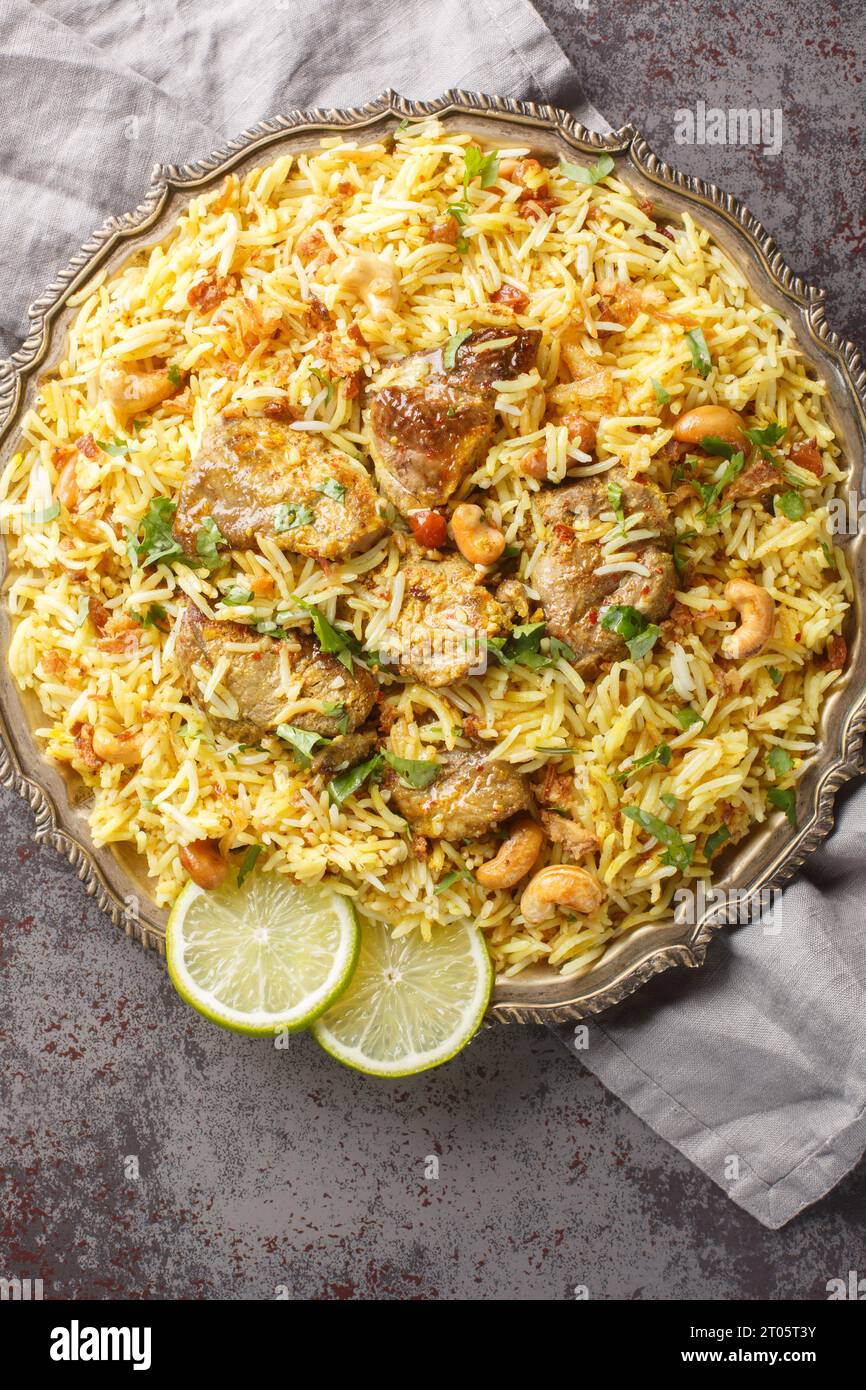 Bengali traditional wedding kacchi biriyani serve with nut, raisins and