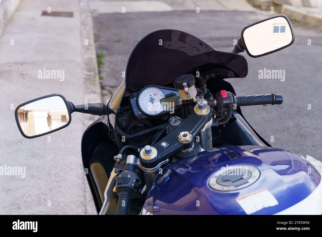 Astorga, Spain - June 4, 2023: Blue Suzuki motorcycle parked in the parking lot. Close-up on the dashboard, mirrors, tank. Stock Photo