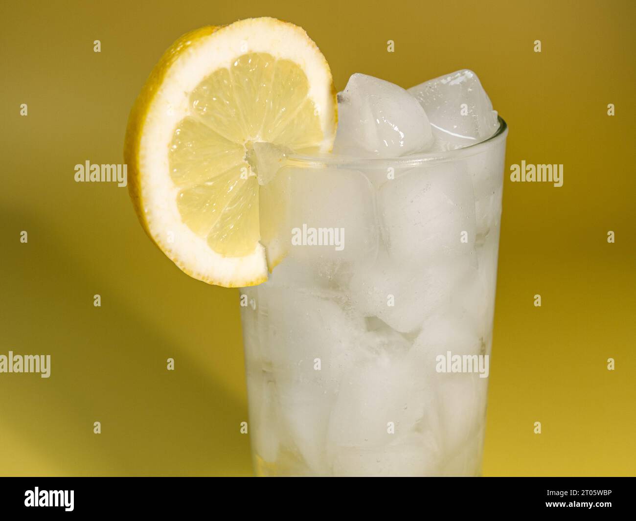 Ice and a slice of lemon in glass of lemonade Stock Photo