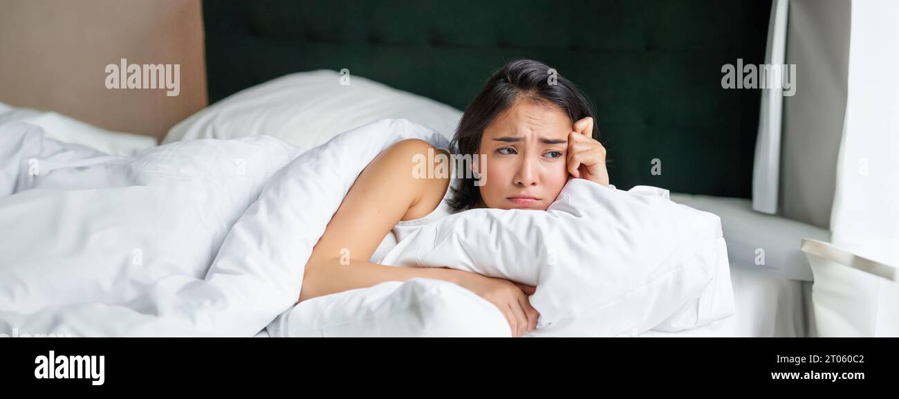 Asian woman crying in bed hi-res stock photography and images - Alamy