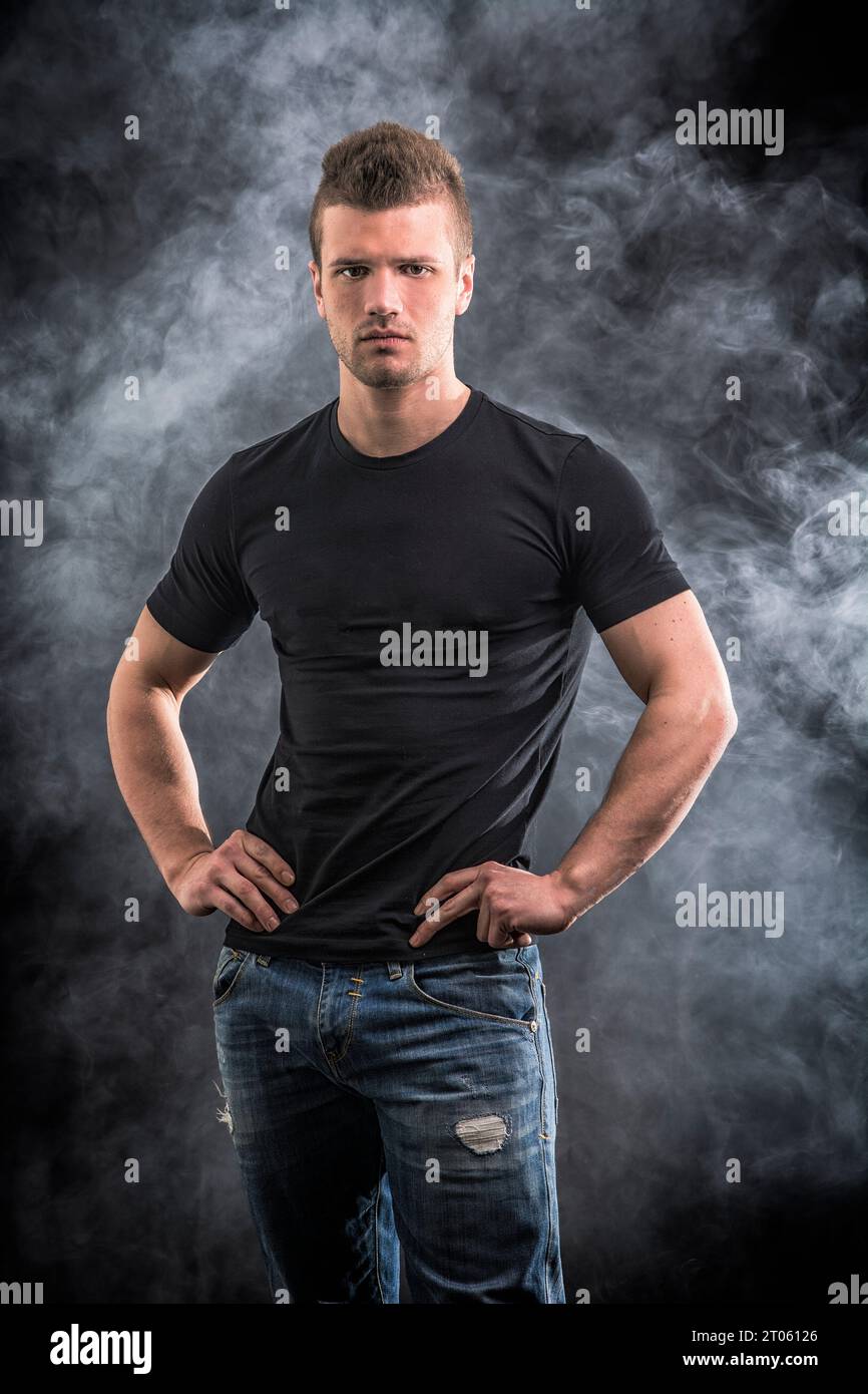 A man standing with his hands on his hips Stock Photo - Alamy