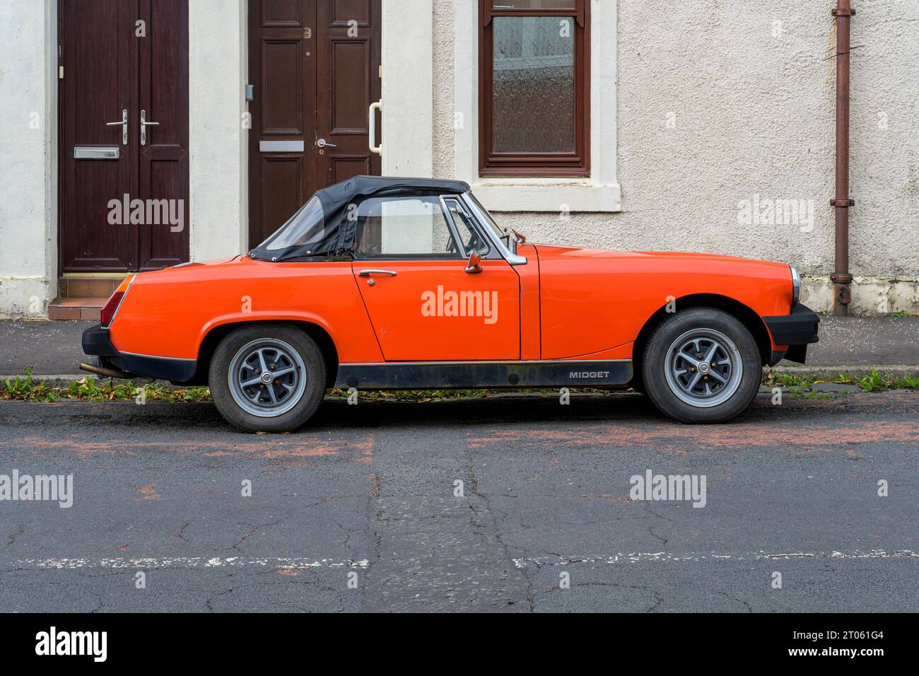 An MG Midget soft top car parked on a street, UK, Europe Stock Photo