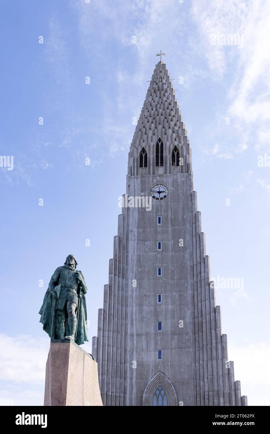 Reykjavik Cathedral or Hallgrímskirkja, a Lutheran Church, seen with the Leif Erikson statue against blue sky,  Reykjavik, Iceland Europe Stock Photo