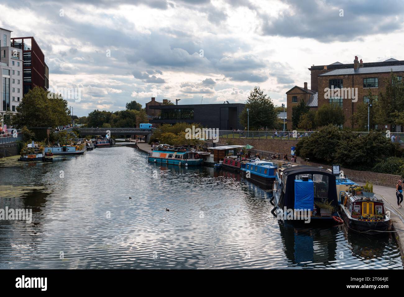 London, UK - August 25, 2023: Regents Canal at Kings Cross. People enjoying the walk by the canal Stock Photo