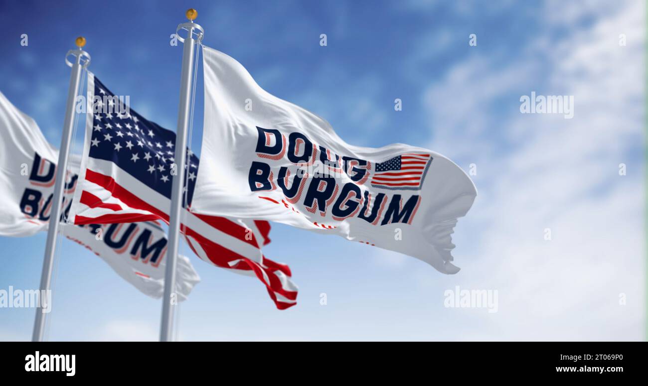Arthut, US, June 2023: Doug Burgum 2024 presidential campaign flags waving with the American flag. 2024 US presidential elections. Illustrative editor Stock Photo
