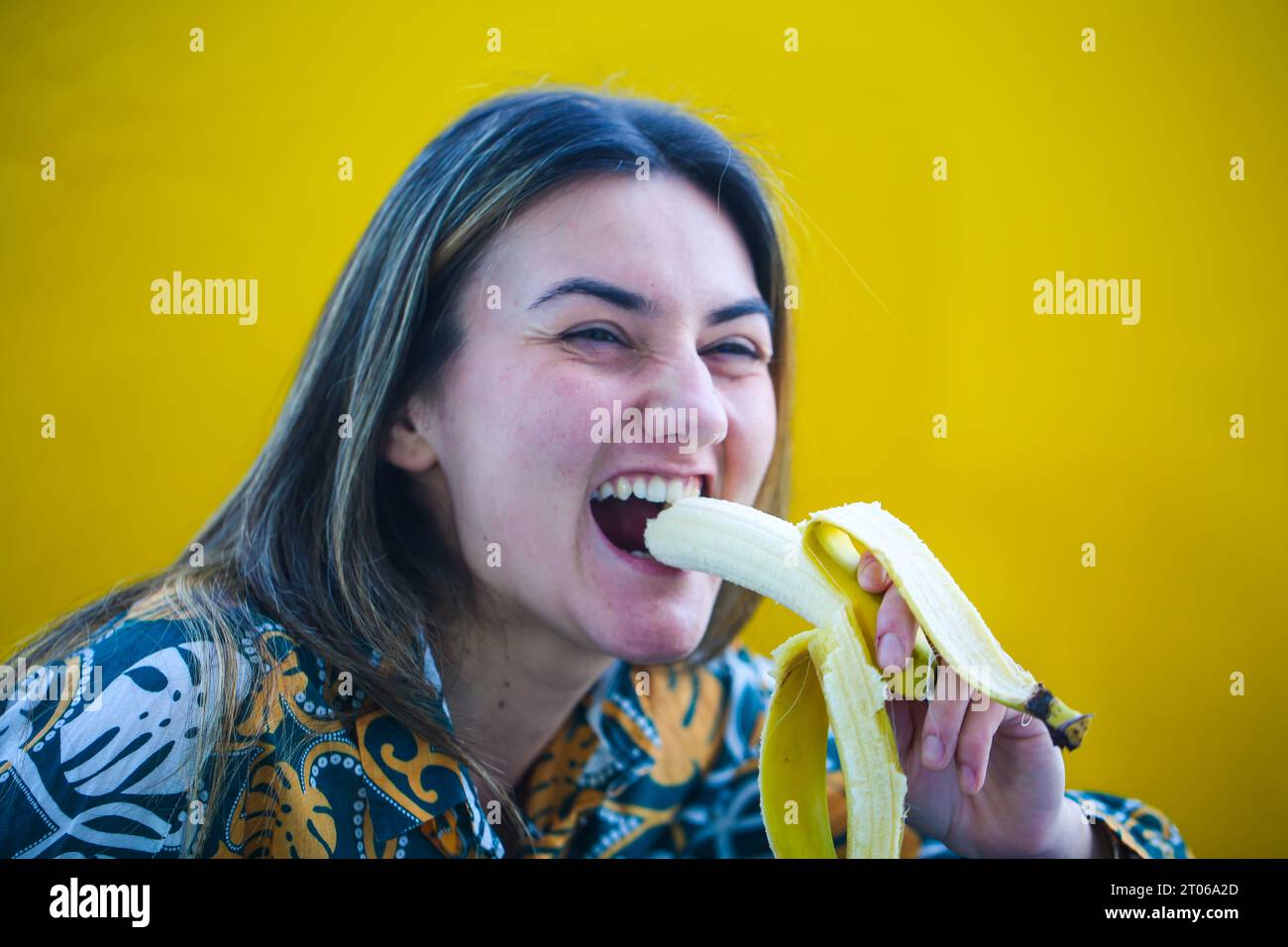 laughing-woman-eating-banana-yellow-background-stock-photo-alamy