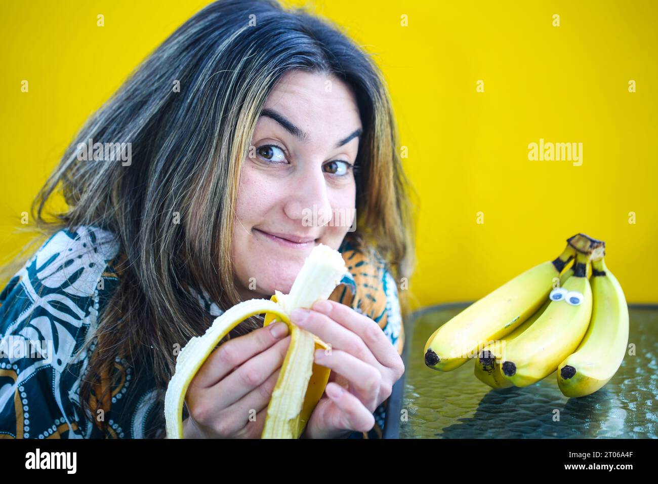 laughing-woman-eating-banana-yellow-background-stock-photo-alamy