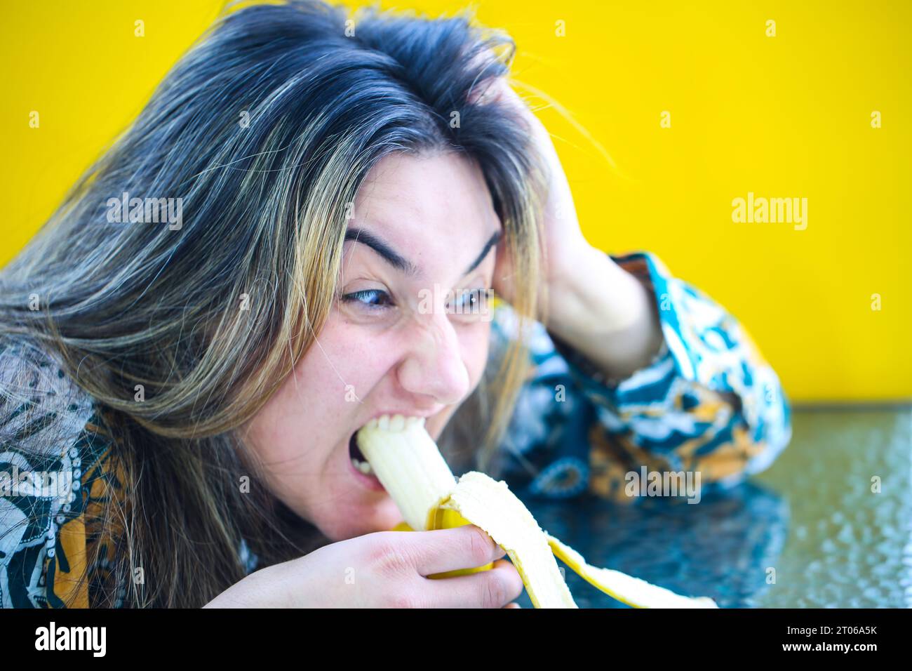 laughing-woman-eating-banana-yellow-background-stock-photo-alamy