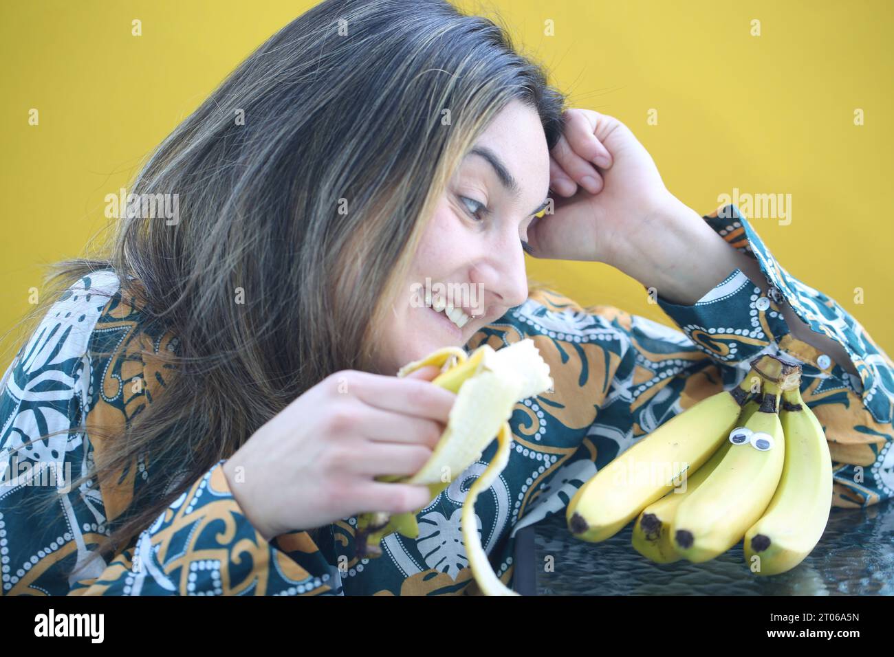 laughing-woman-eating-banana-yellow-background-stock-photo-alamy