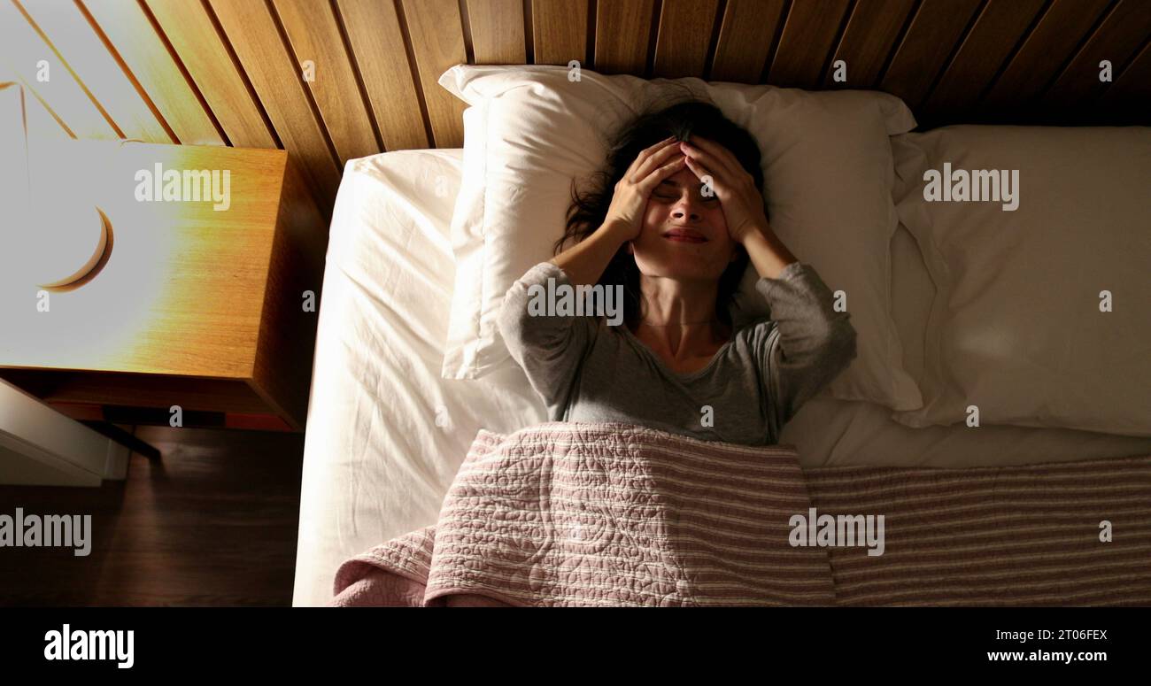 Worried woman unable to sleep suffering from insomnia. Person tossing