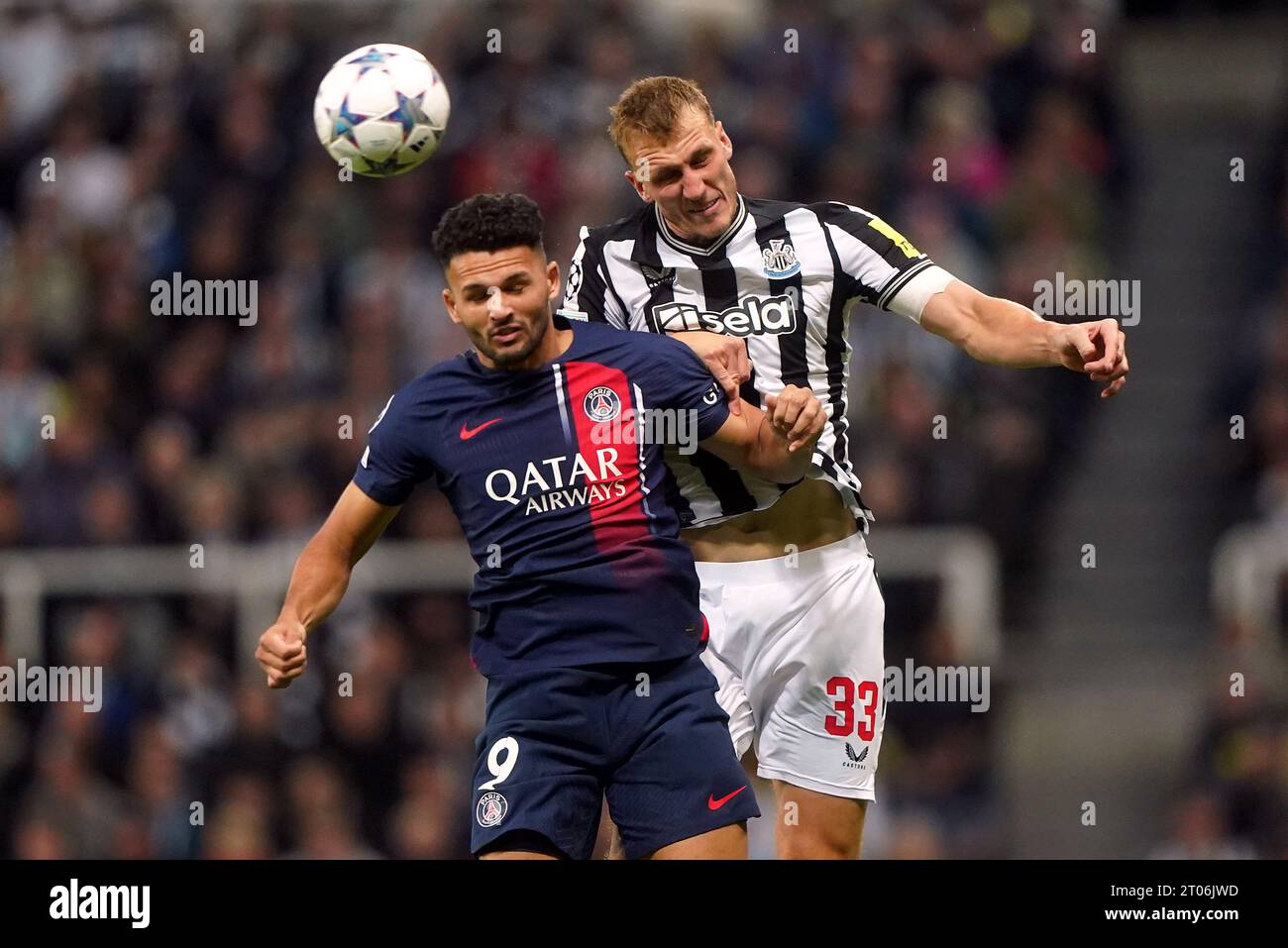 Paris Saint-Germain's Goncalo Ramos and Newcastle United's Dan Burn (right) battle for the ball during the UEFA Champions League Group F match at St. James' Park, Newcastle upon Tyne. Picture date: Wednesday October 4, 2023. Stock Photo