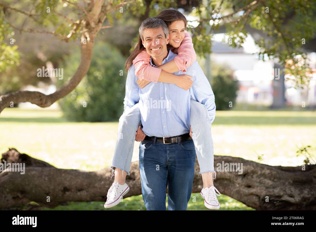 Romantic Middle Aged Couple Having Fun While Walking Together Outdoors Stock Photo