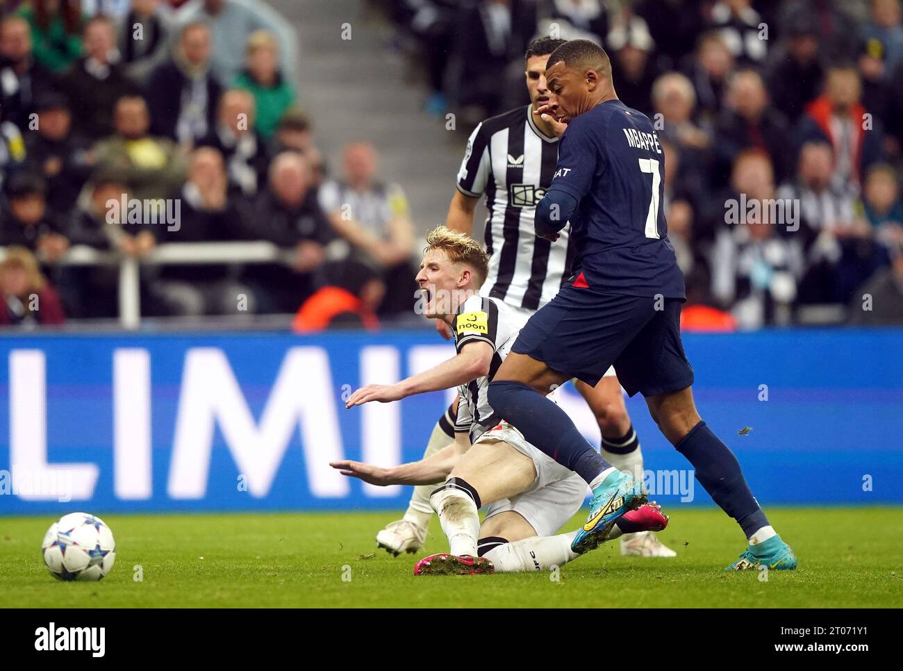 Newcastle United's Anthony Gordon goes down under the challenge from Paris Saint-Germain's Kylian Mbappe during the UEFA Champions League Group F match at St. James' Park, Newcastle upon Tyne. Picture date: Wednesday October 4, 2023. Stock Photo
