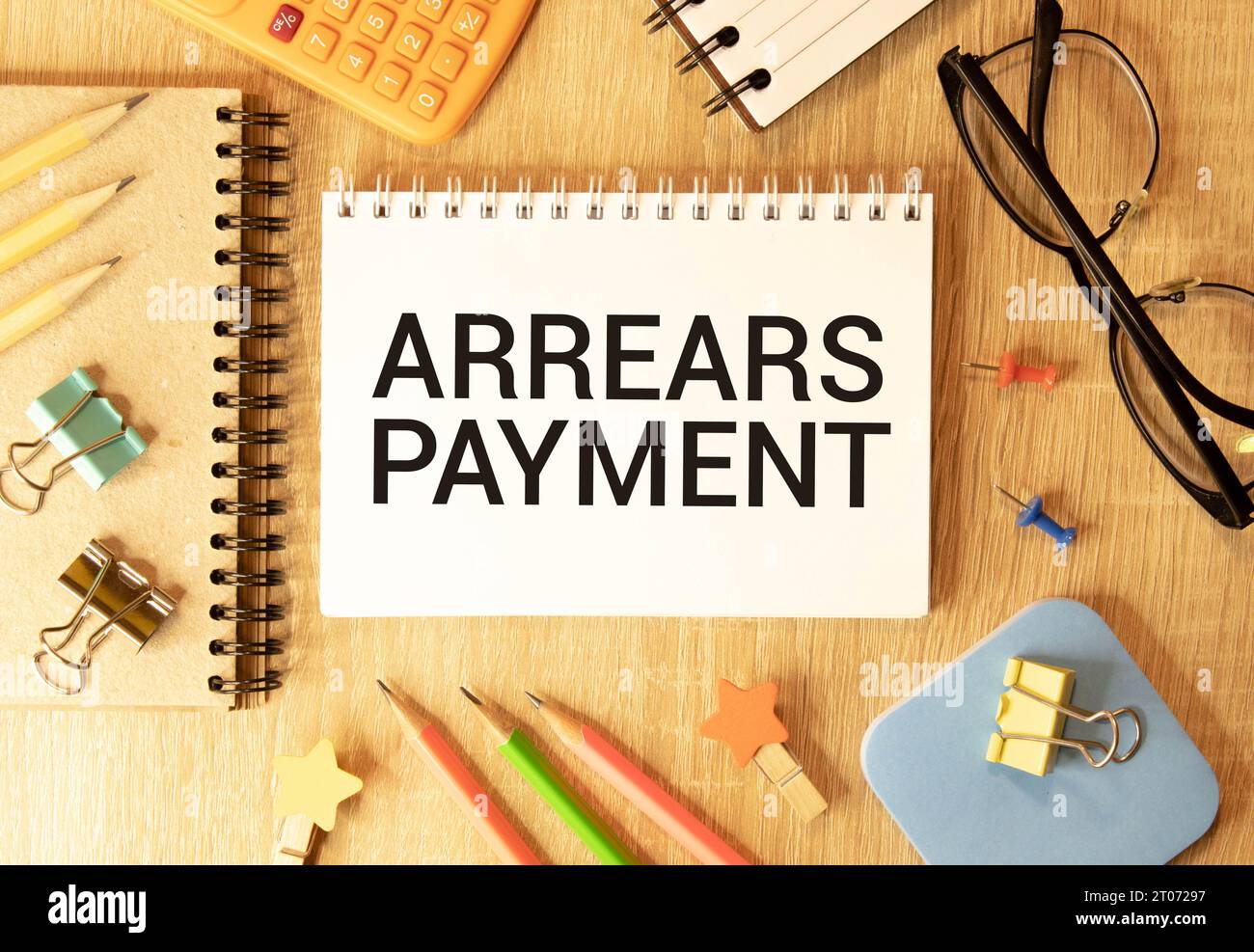 Arrears Payment write on a book isolated on Wooden Table Stock Photo