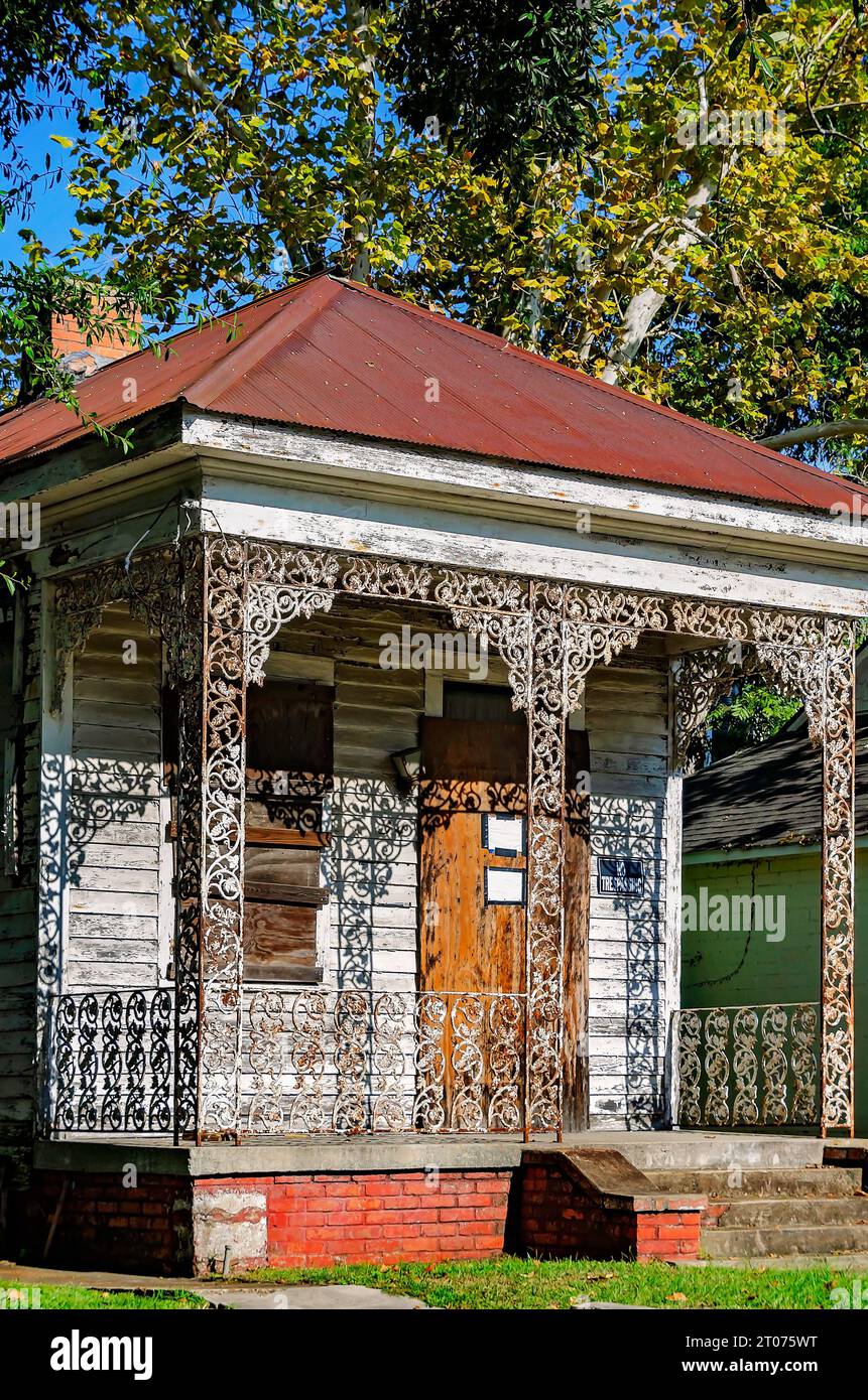 A historic shotgun house is boarded up and dilapidated in the Central Business District, Sept. 30, 2023, in Mobile, Alabama. Stock Photo