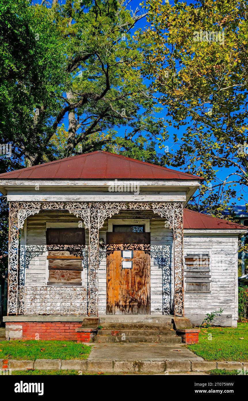A historic shotgun house is boarded up and dilapidated in the Central Business District, Sept. 30, 2023, in Mobile, Alabama. Stock Photo