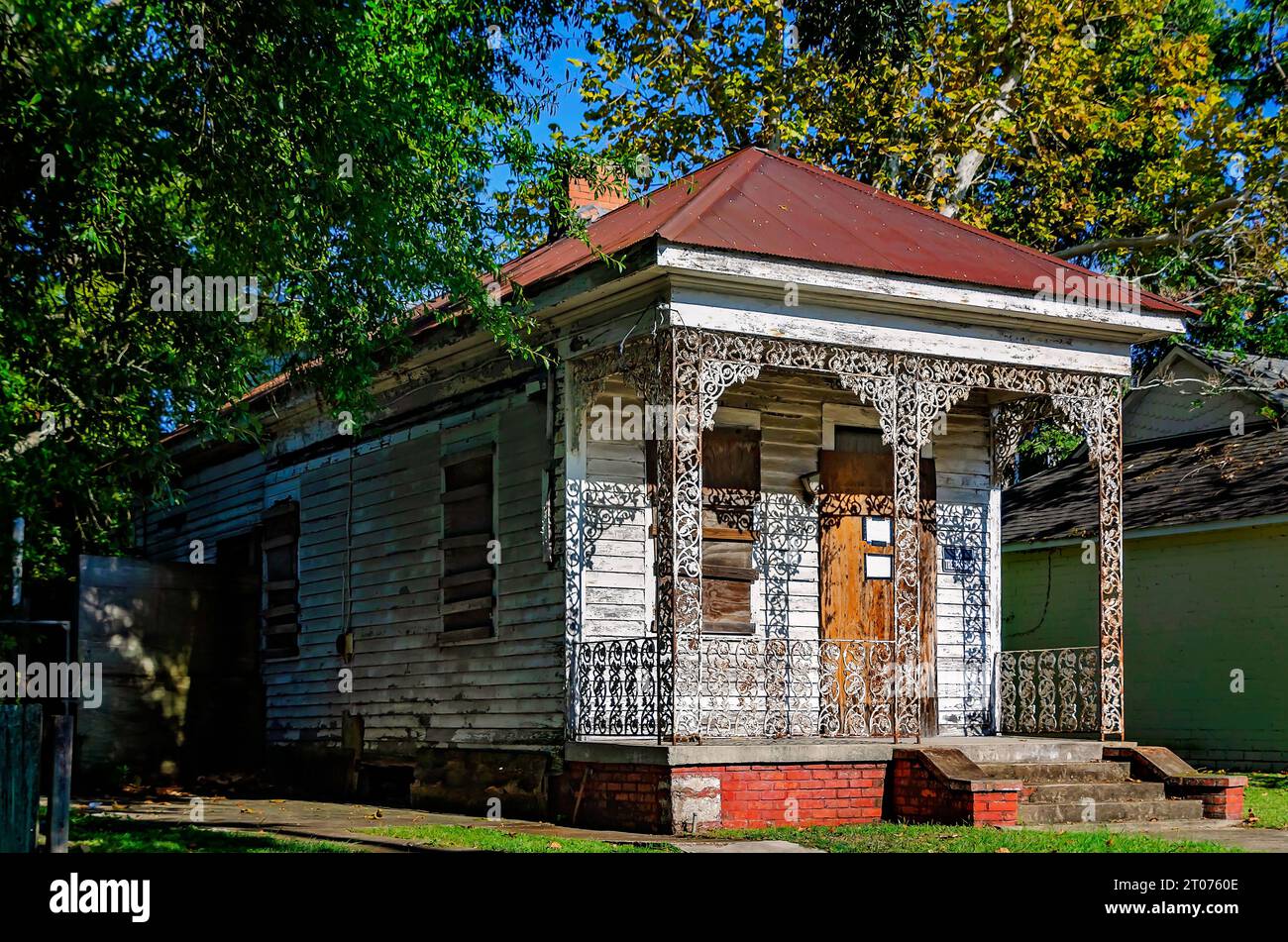 A historic shotgun house is boarded up and dilapidated in the Central Business District, Sept. 30, 2023, in Mobile, Alabama. Stock Photo