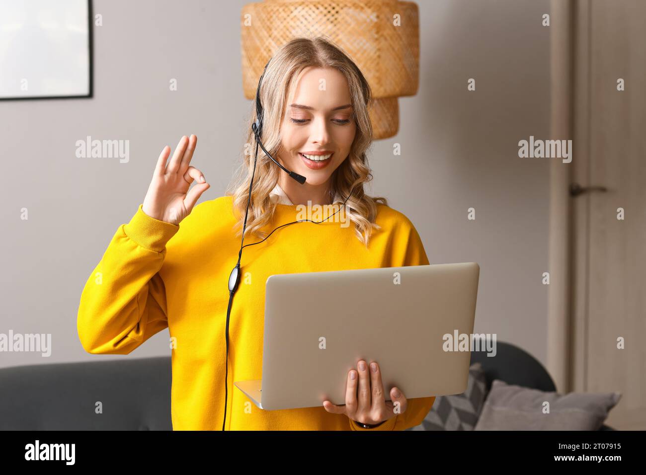 Female technical support agent with laptop working at home Stock Photo ...