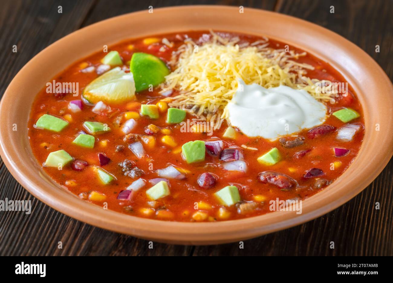 Bowl of taco soup garnished with cheese and sour cream Stock Photo