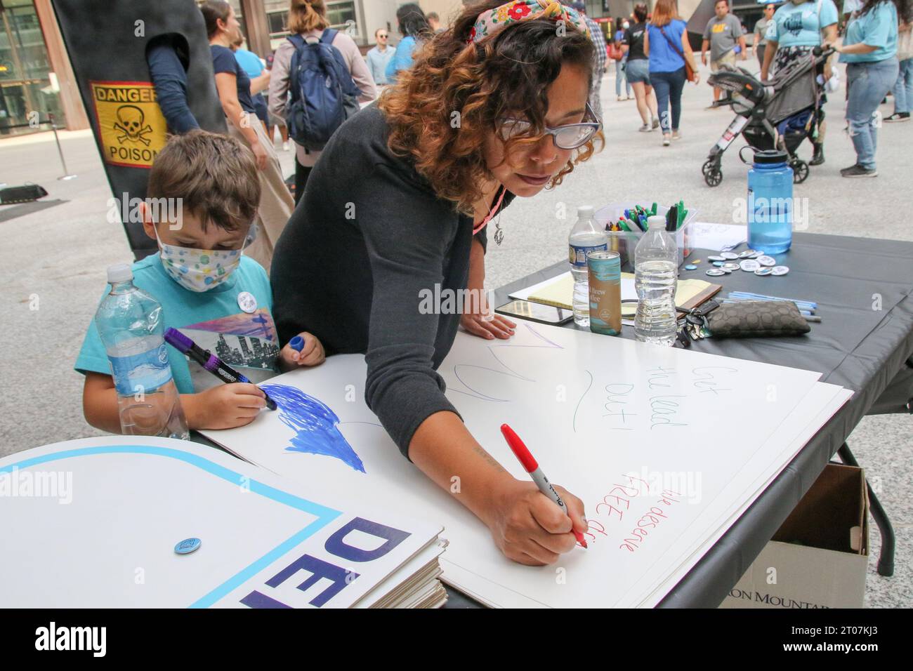 a-mother-and-her-son-make-banners-for-the-let-s-get-the-lead-out