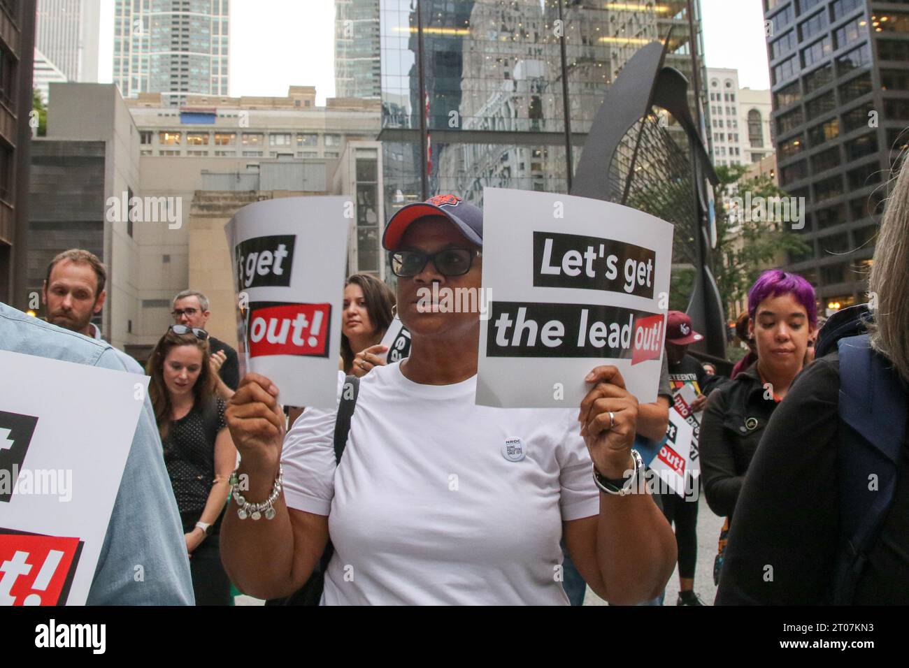 People attend the Let's Get the Lead Out, Chicago! rally alongside some ...