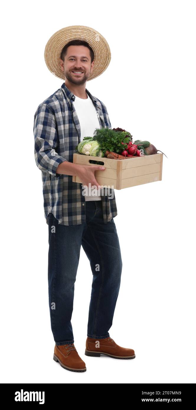 Harvesting season. Happy farmer holding wooden crate with vegetables on ...