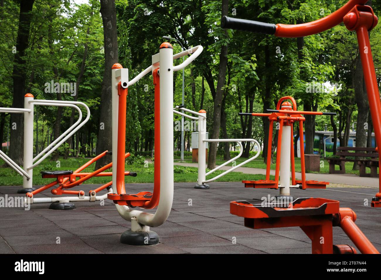 Empty outdoor gym with air walker, push up bars, rowing machine and double abductor Stock Photo