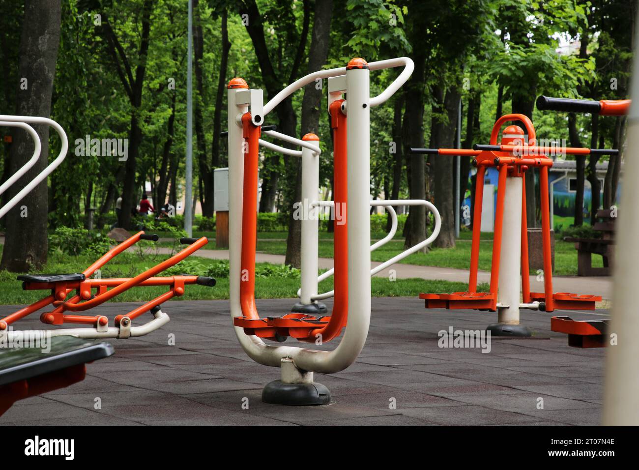 Empty outdoor gym with air walker, push up bars, rowing machine and double abductor Stock Photo