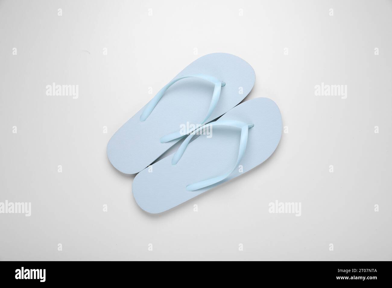 Light blue flip flops on white background, top view Stock Photo - Alamy