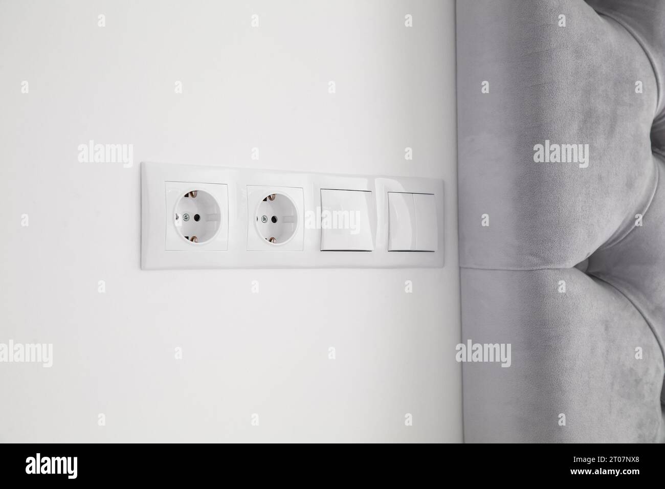 Light switches and power sockets on white wall indoors Stock Photo Alamy