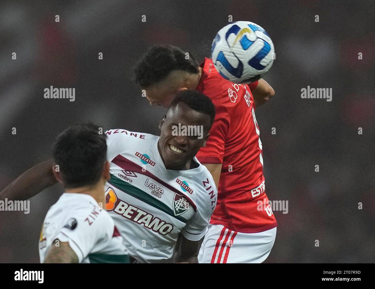 Samuel Xavier of Brazil's Fluminense, center, and Rene of Brazil's  Internacional head the ball during a Copa Libertadores semifinal second leg  soccer match at Beira Rio stadium in Porto Alegre, Brazil, Wednesday