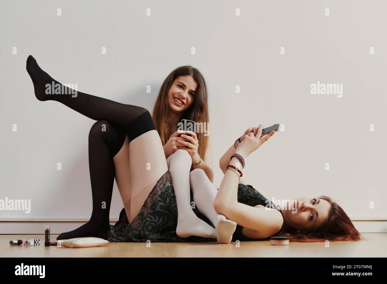 Reveling in youth, two women embrace self-expression, aware that societal judgments may later confine them Stock Photo